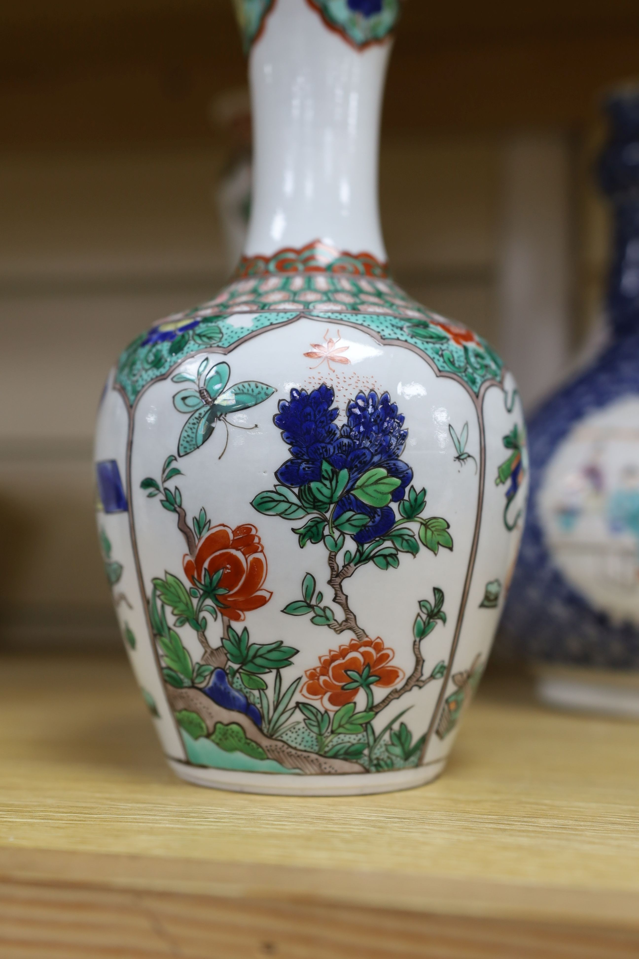 A pair Samson of Paris vases in the Chinese famille verte style and a Chinese Qianlong famille rose garlic neck vase with blue panelling motif, tallest 26cm